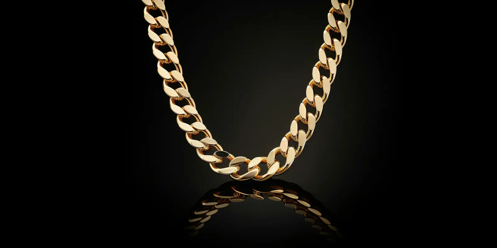 Gold Cuban link chain on black